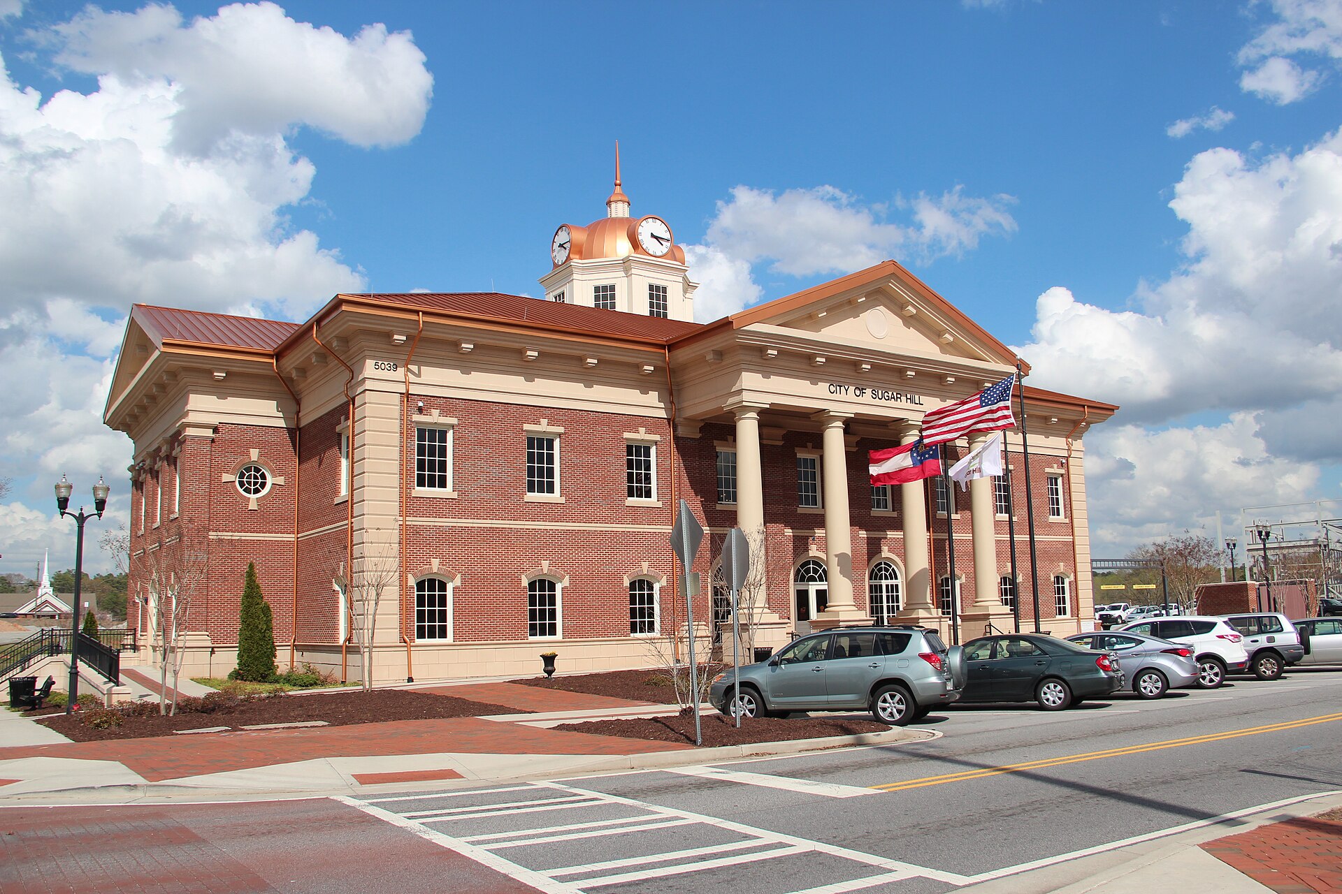 Sugar Hill City Hall and its copper-colored clock tower